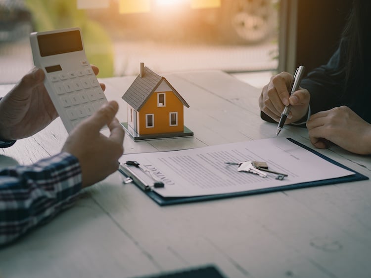 Real estate professionals offer their clients contracts.
